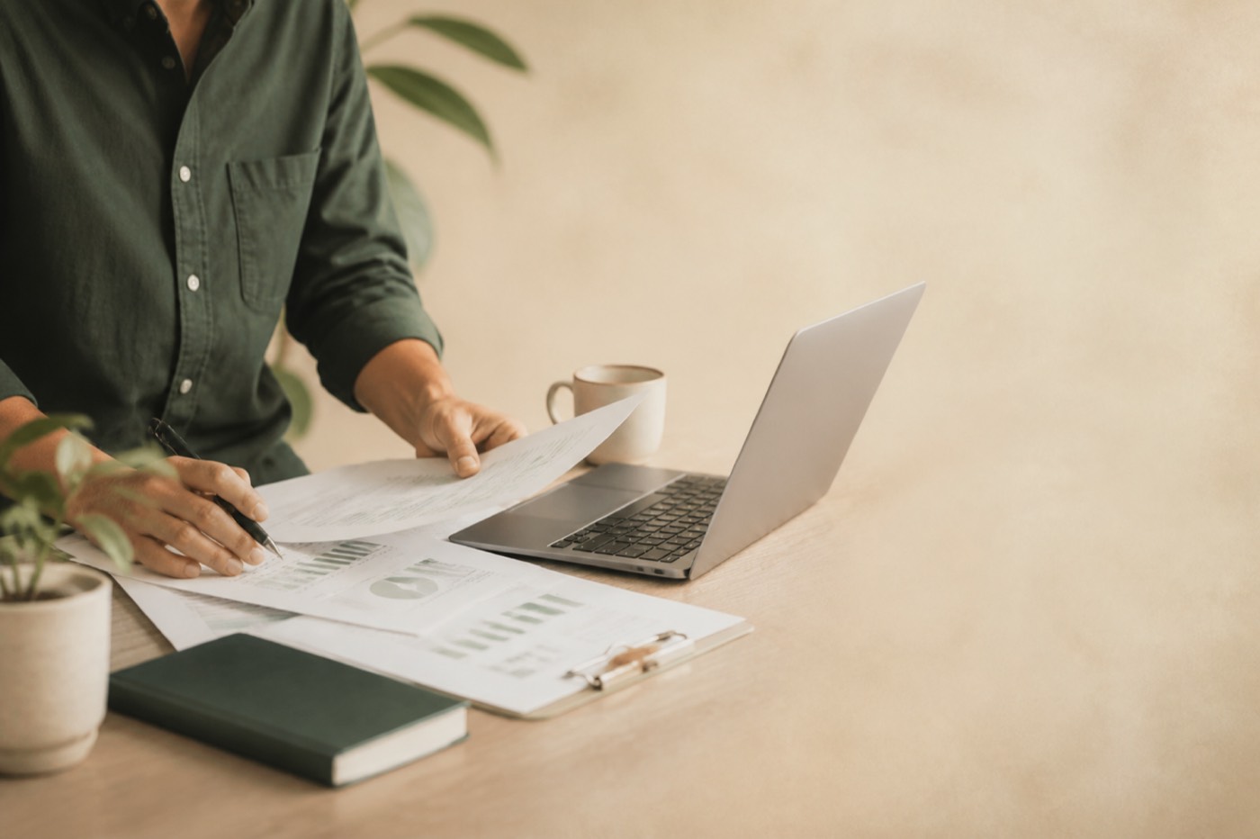 Seller reviewing tax reports at a desk, face not shown